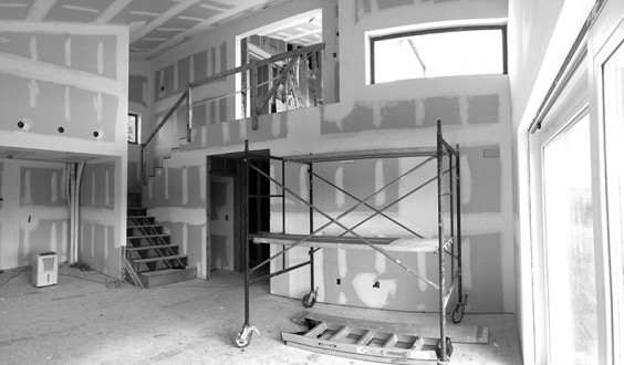 Finished sheetrock awaiting priming and painting in the double-height living room